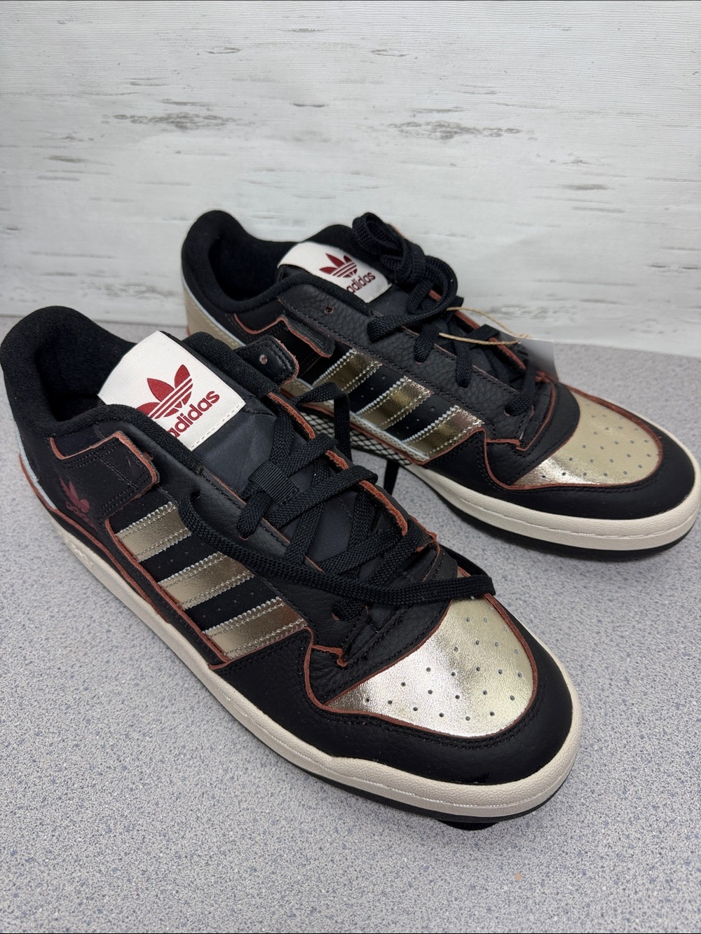 adidas Low-Top Sneakers in Black and Metallic Gold with Red Accents